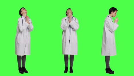 Religious-woman-physician-praying-to-jesus-christ-against-greenscreen